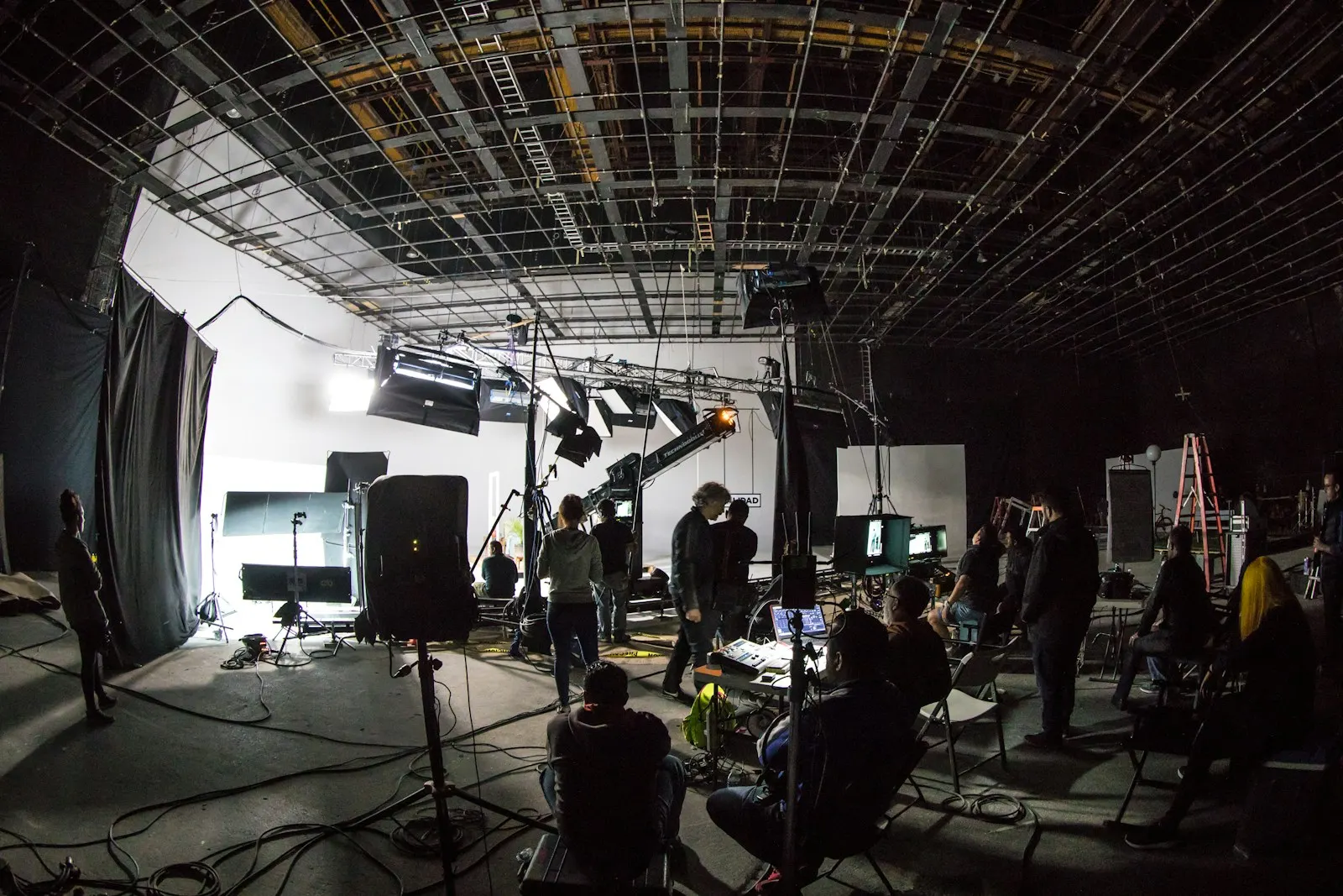 Crew gathered around monitors on a production set