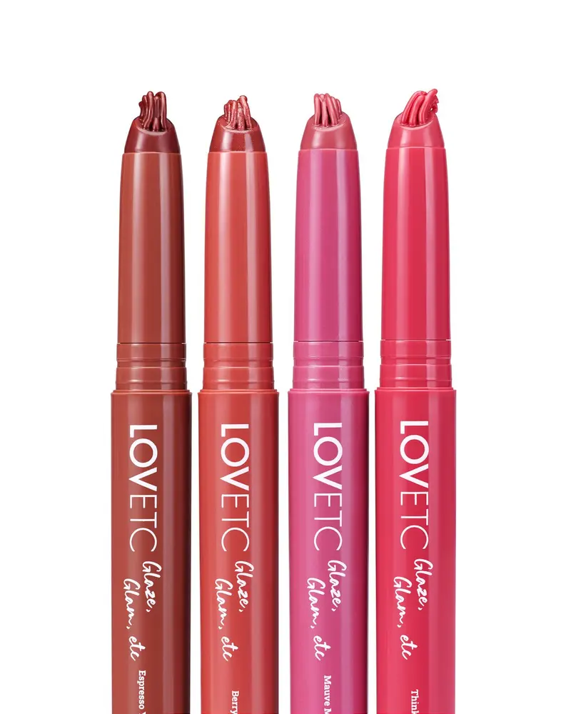 Four LOVETC lip conditioners in brown, coral, mauve and pink lined up on white
