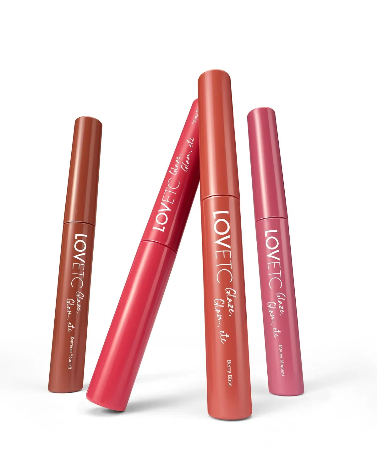 Four LOVETC lip conditioners leaning together in a product still life on white