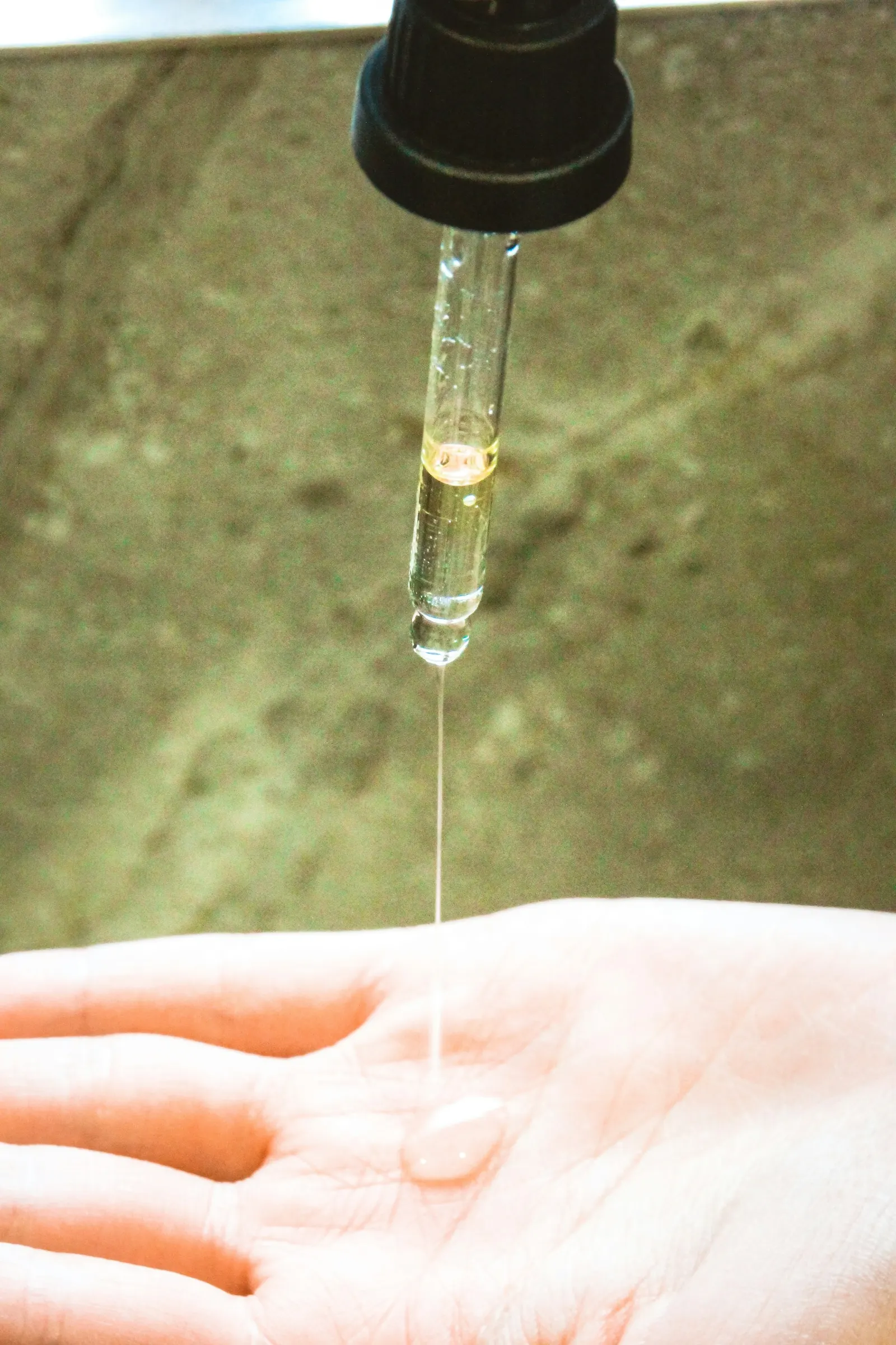 Clear serum stretching in a thin string from a glass pipette onto a palm