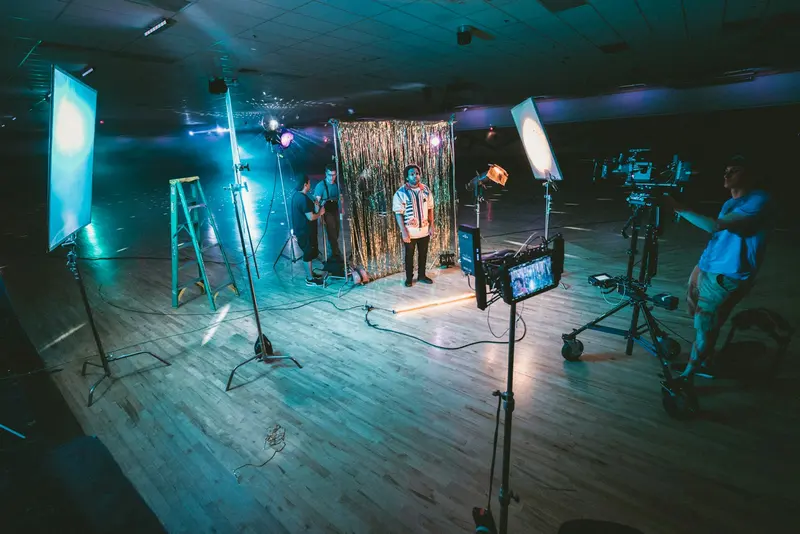 Studio set with a tinsel backdrop, lights and a camera